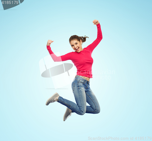 Image of smiling young woman jumping in air