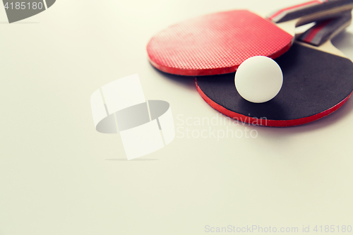 Image of close up of table tennis rackets with ball