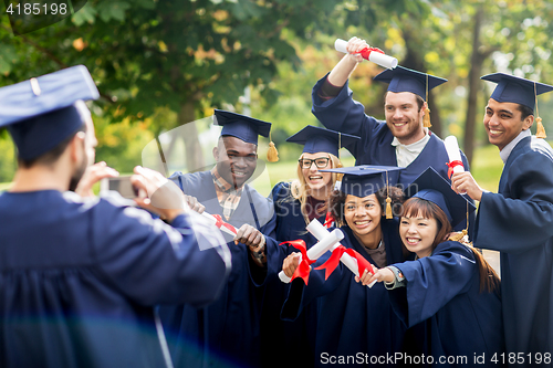Image of students or bachelors photographing by smartphone