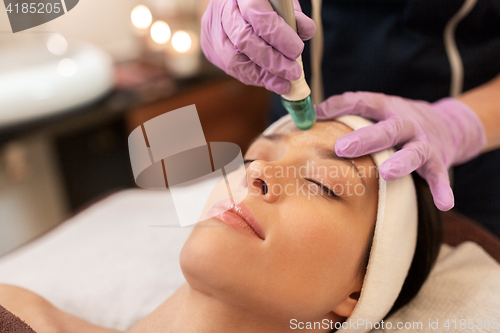 Image of woman having microdermabrasion facial treatment