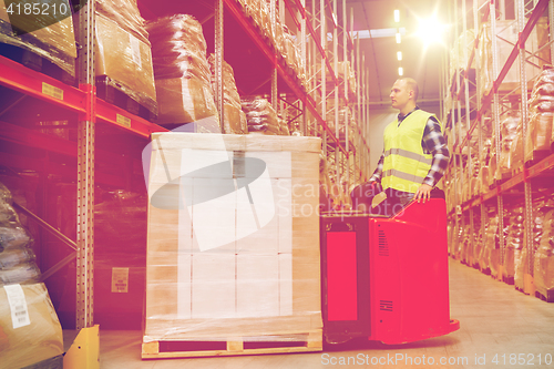 Image of man on forklift loading cargo at warehouse