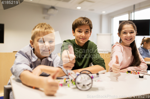 Image of happy children building robots at robotics school