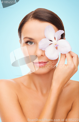 Image of beautiful young woman with orchid flower