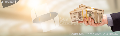 Image of Male Hand Holding Stack of Cash Wide Banner With Room For Copy.