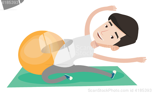 Image of Young man exercising with fitball.