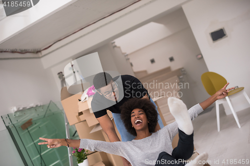 Image of African American couple  playing with packing material