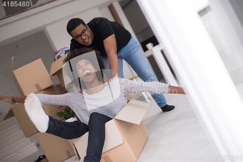 Image of African American couple  playing with packing material