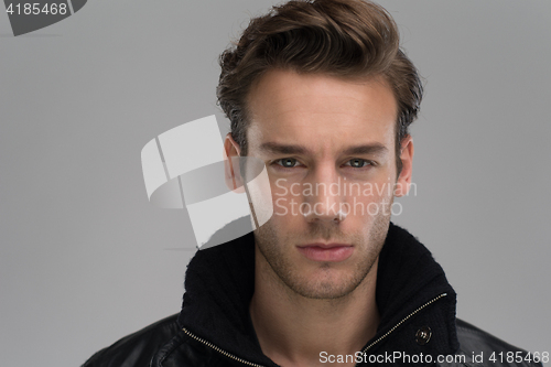 Image of portrait of a young guy over gray background