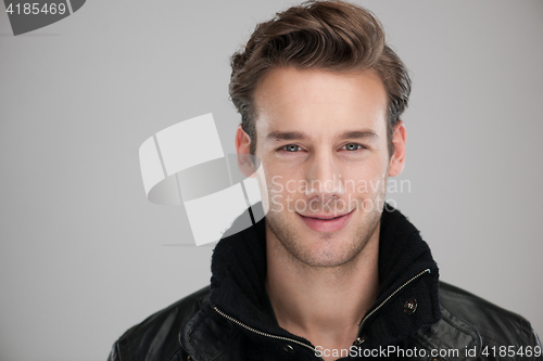 Image of portrait of a young guy over gray background