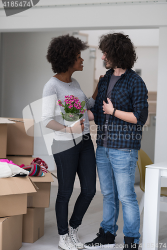 Image of multiethnic couple moving into a new home