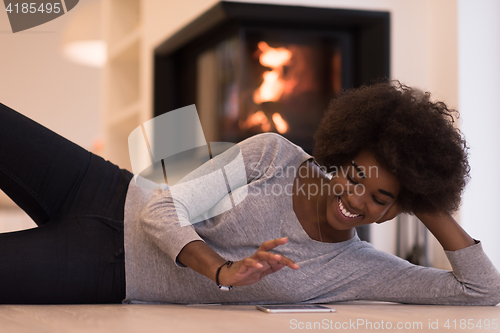 Image of black women used tablet computer on the floor