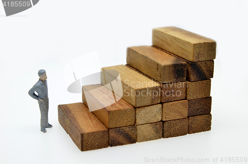 Image of Way to success with  businessman and wood block step