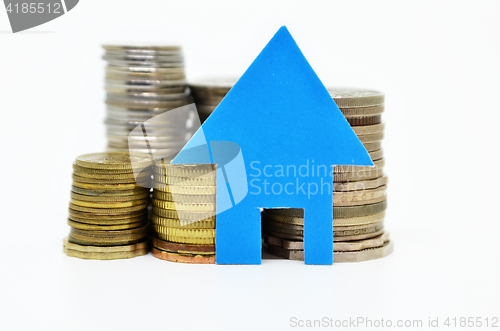 Image of House model and stacks of coins