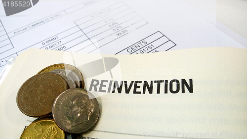 Image of Reinvention word on the book with balance sheet 