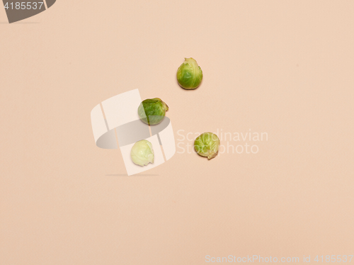 Image of The piles of Brussels sprouts on a pink background