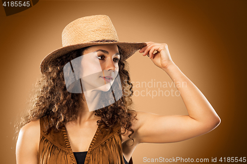 Image of The cowgirl fashion woman over a brown background