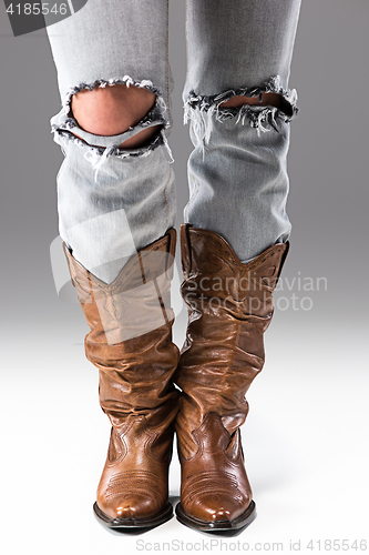 Image of Legs in Jeans and Cowboys Boots