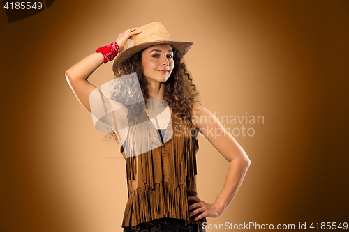 Image of The cowgirl fashion woman over a brown background