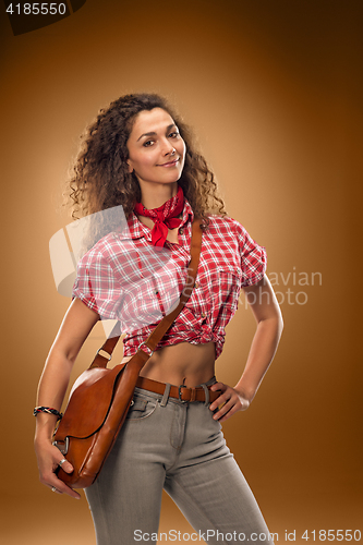 Image of The cowgirl fashion woman over a brown background