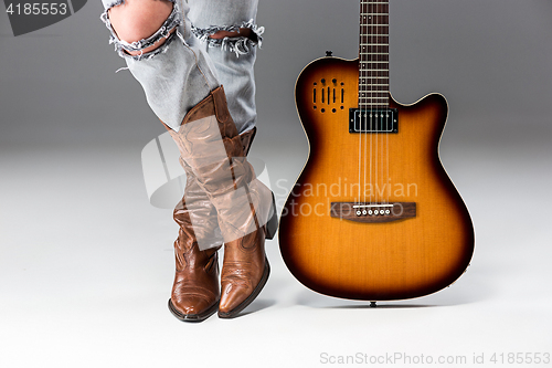 Image of Legs in Jeans and Cowboys Boots