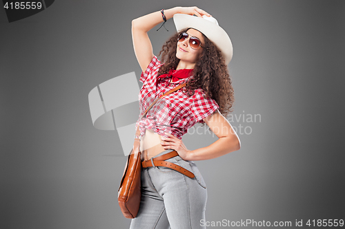 Image of The cowgirl fashion woman over a gray background