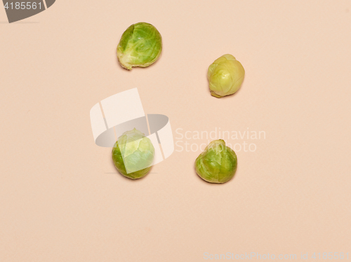 Image of The piles of Brussels sprouts on a pink background