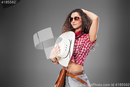 Image of The cowgirl fashion woman over a gray background