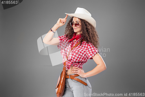 Image of The cowgirl fashion woman over a gray background