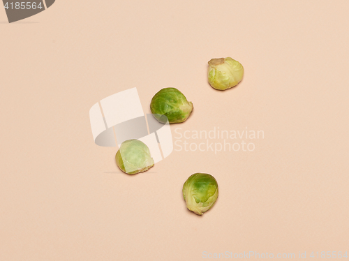 Image of The piles of Brussels sprouts on a pink background