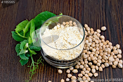 Image of Flour chickpeas in glassful with green peas on board