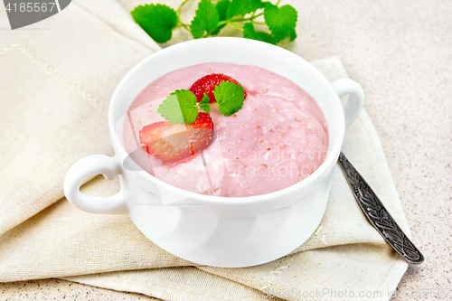 Image of Soup strawberry in white bowl on stone table