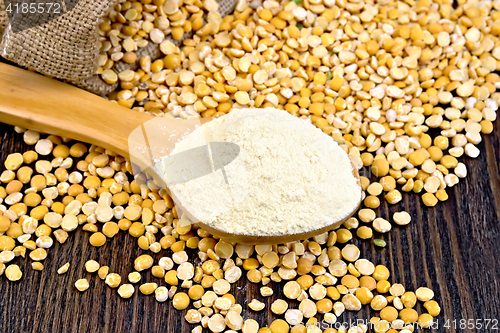 Image of Flour pea in wooden spoon on board