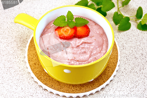 Image of Soup strawberry in yellow bowl on granite table