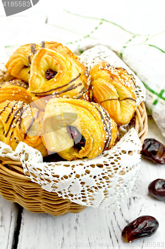 Image of Cookies with dates in wicker basket on board