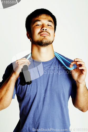 Image of young asian guy with skipping rope on white background ready to 