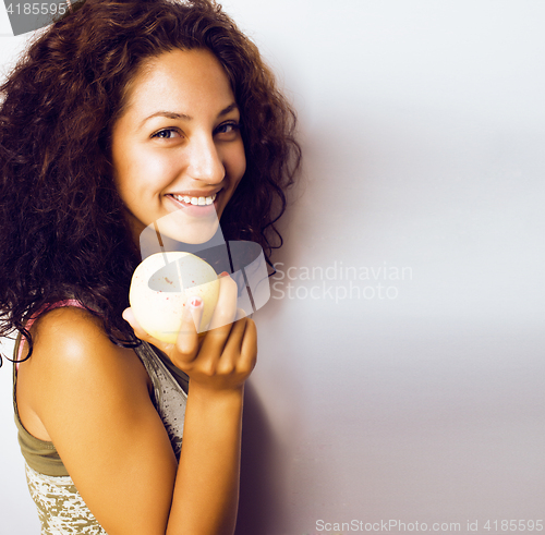 Image of pretty young real tenage girl eating apple close up smiling