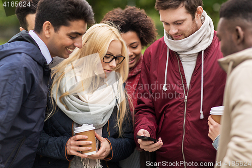 Image of happy friends with smartphone and coffee outdoors