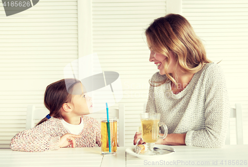 Image of happy family having dinner at restaurant or cafe