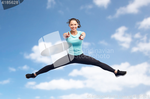 Image of happy smiling sporty young woman jumping in air