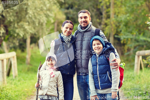 Image of happy family with backpacks hiking