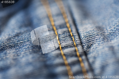 Image of close up of stitching on denim or jeans clothes