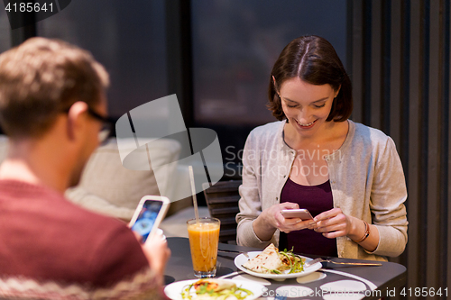 Image of happy couple having dinner at vegan restaurant