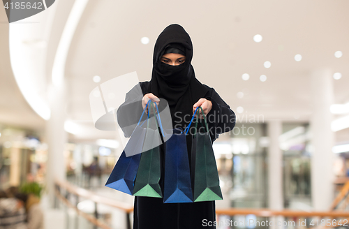 Image of muslim woman in hijab with shopping bags