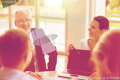 Image of business people with laptop meeting in office