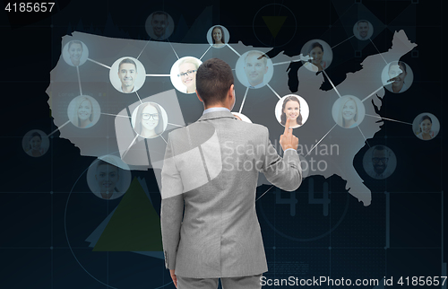 Image of businessman touching virtual screen with contacts