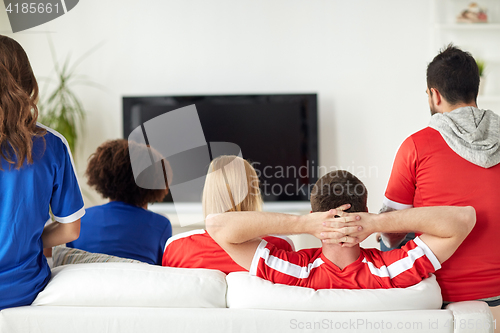 Image of friends or football fans watching tv at home