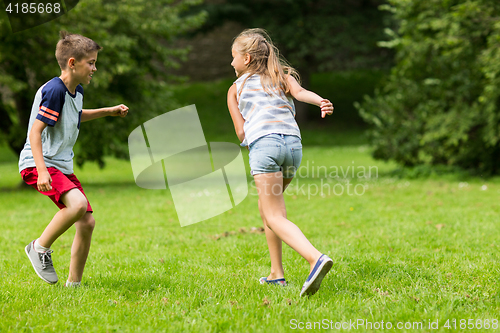 Image of group of happy kids or friends playing outdoors