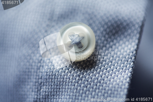 Image of close up of blue shirt button