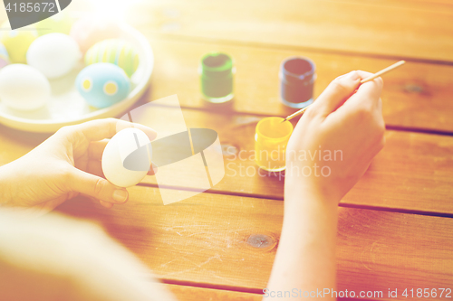 Image of close up of woman coloring easter eggs