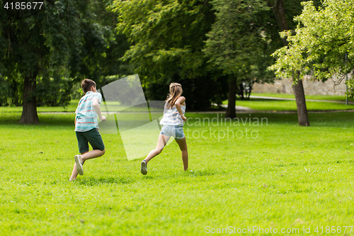 Image of group of happy kids or friends playing outdoors